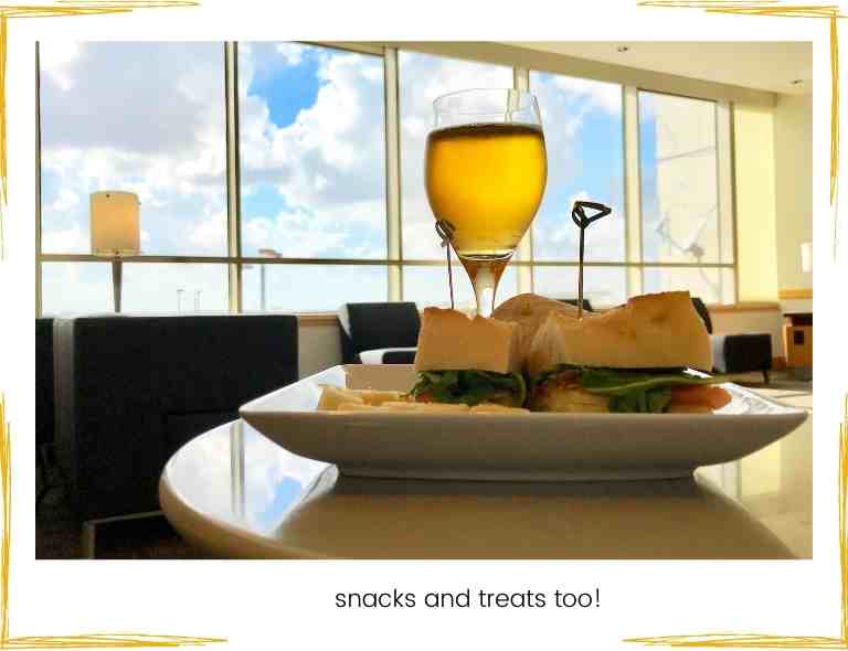 picture shows glass of wine and snack in an airport lounge airport lounge pass